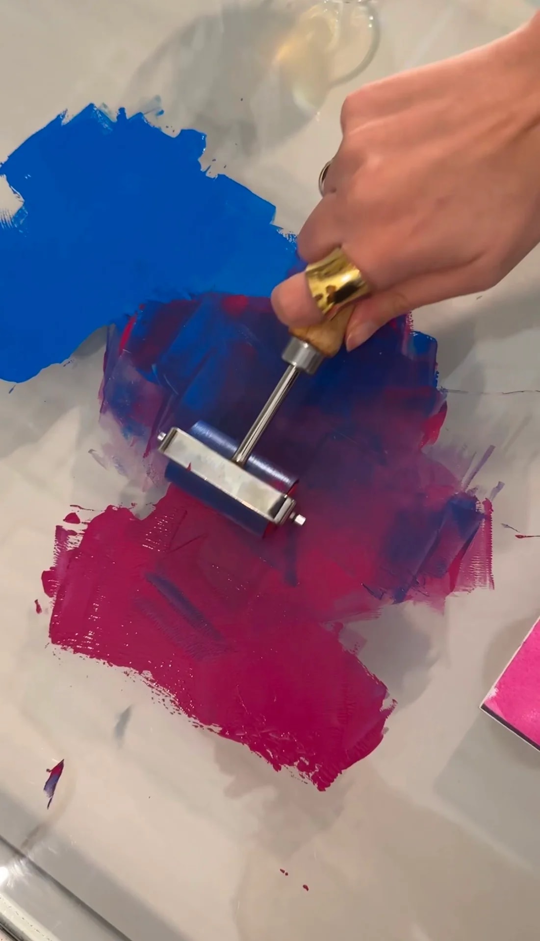 Rolling blue and pink ink with a brayer for printmaking
