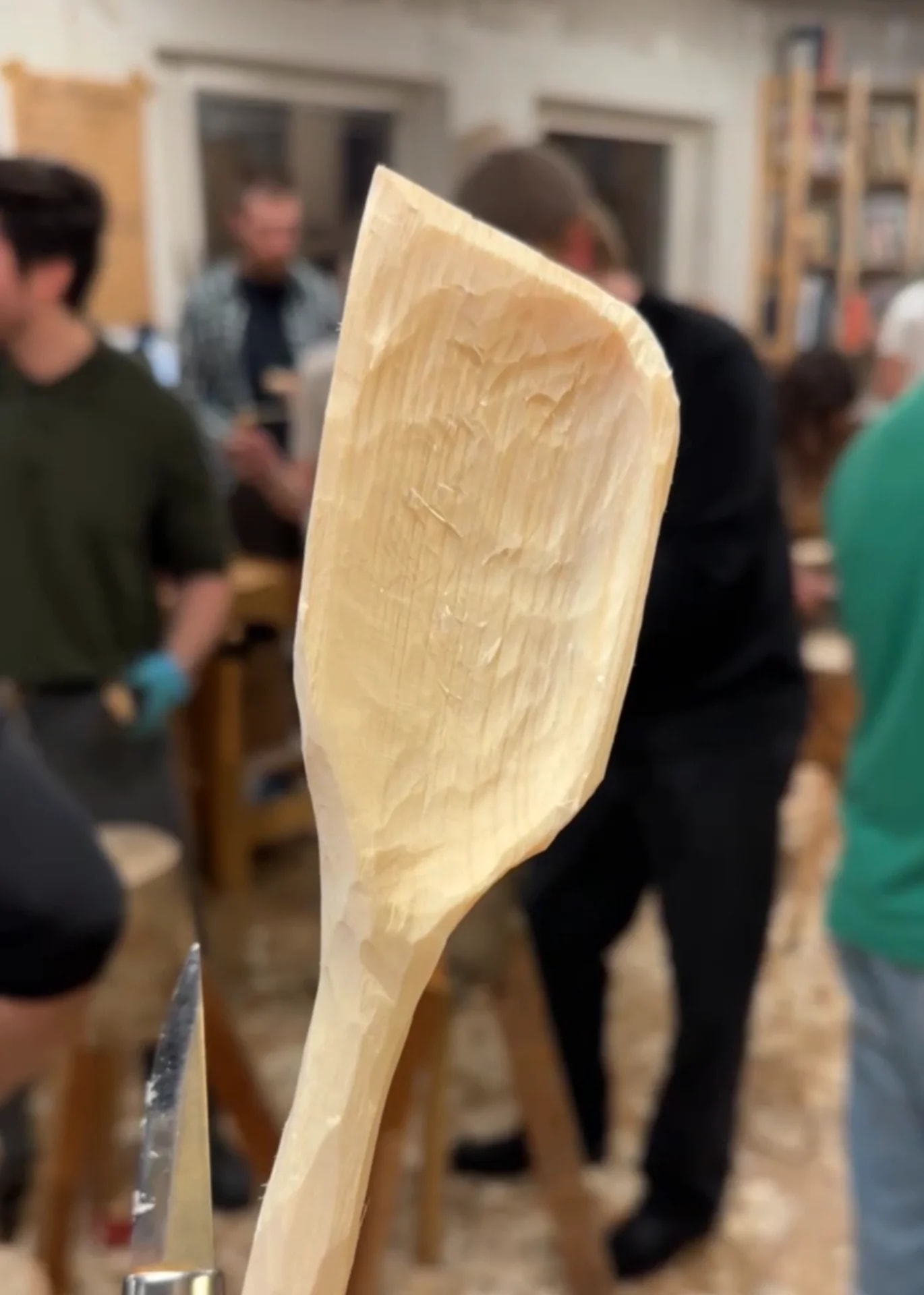 Hand-carved wooden spatula at a woodworking workshop